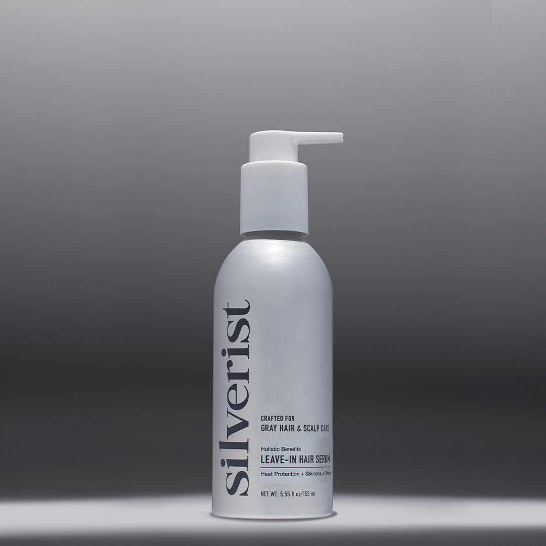 A pump bottle of Silverist Holistic Benefits Leave-In Hair Serum with a white label on a silver background.