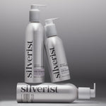 Three Silverist haircare products including shampoo, conditioner, and leave-in hair serum, in aluminum bottles with silver text and accents.