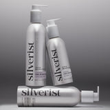 Three Silverist haircare products including shampoo, conditioner, and leave-in hair serum, in aluminum bottles with silver text and accents.