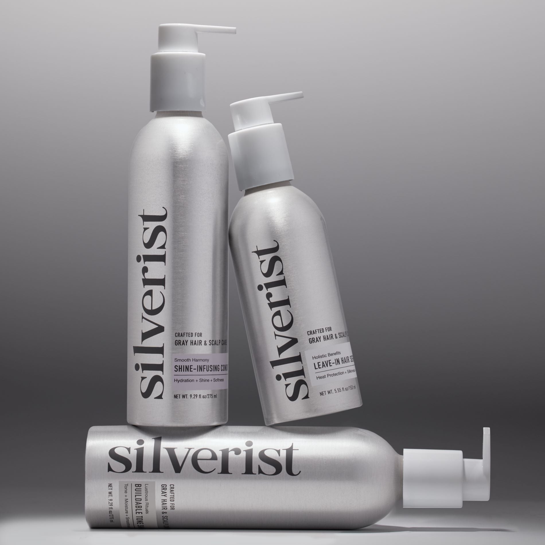 Three Silverist haircare products including shampoo, conditioner, and leave-in hair serum, in aluminum bottles with silver text and accents.