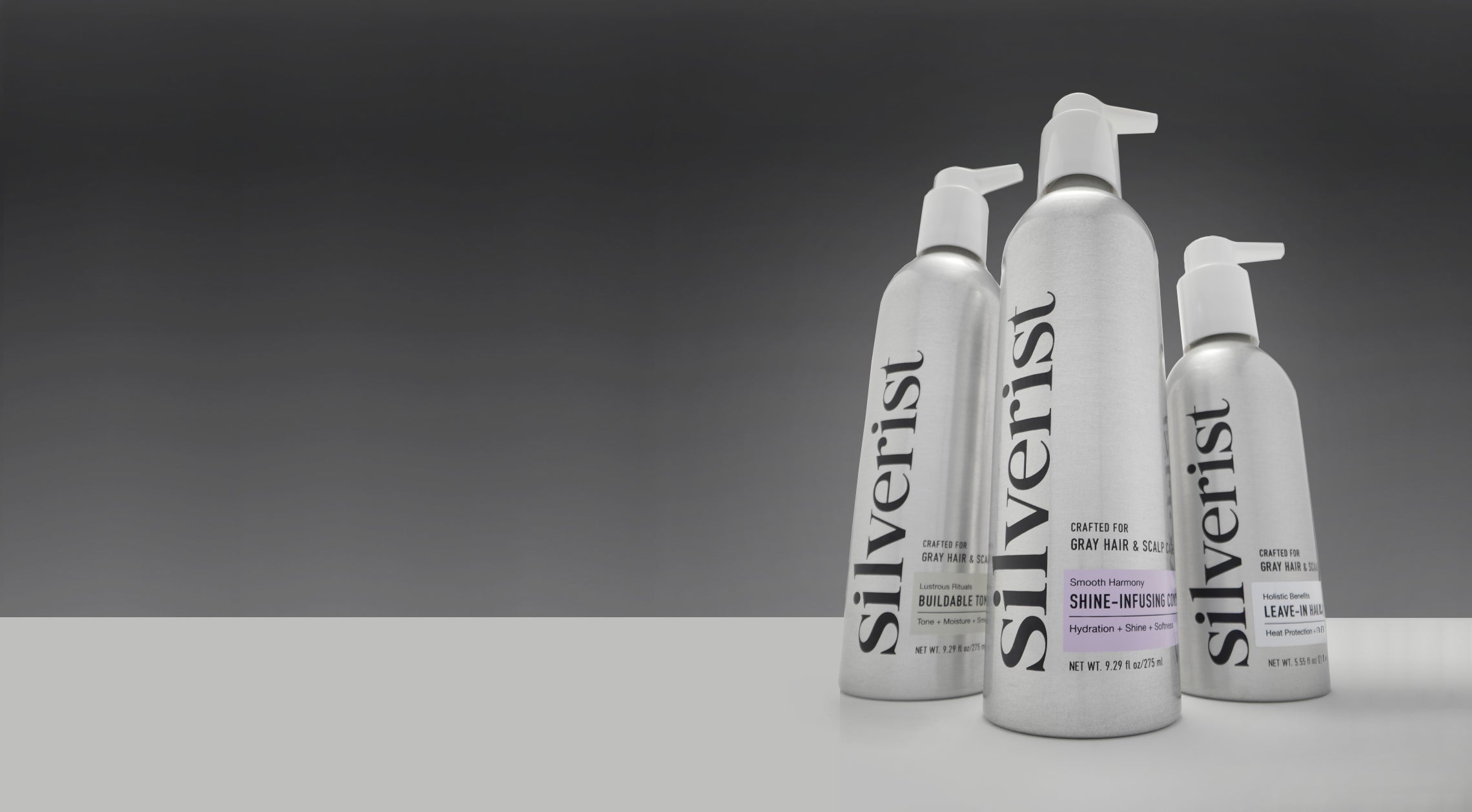Three bottles of Silverist hair care products on a gray background