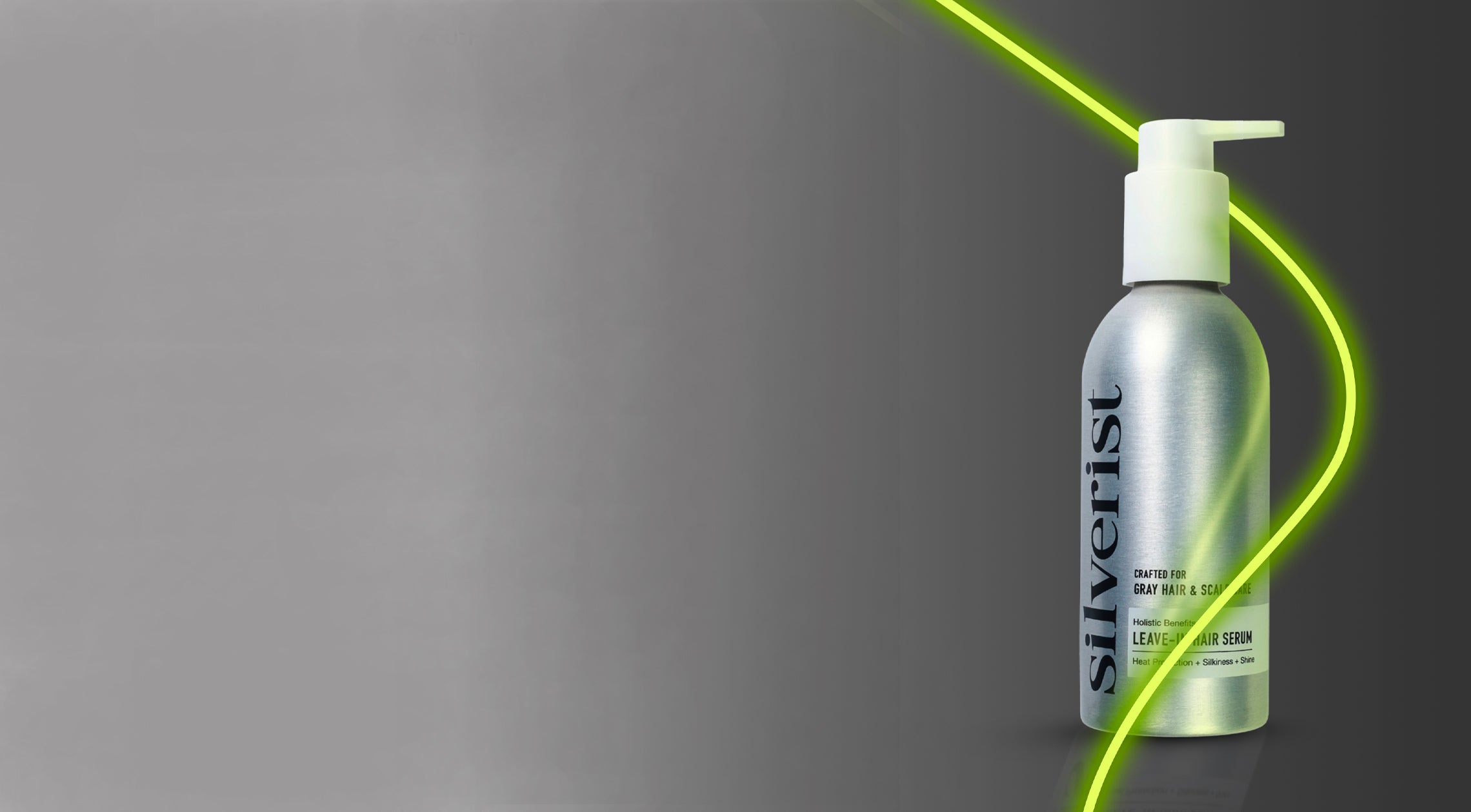 Silver bottle of the Leave-In Serum with pump dispenser on a gray background