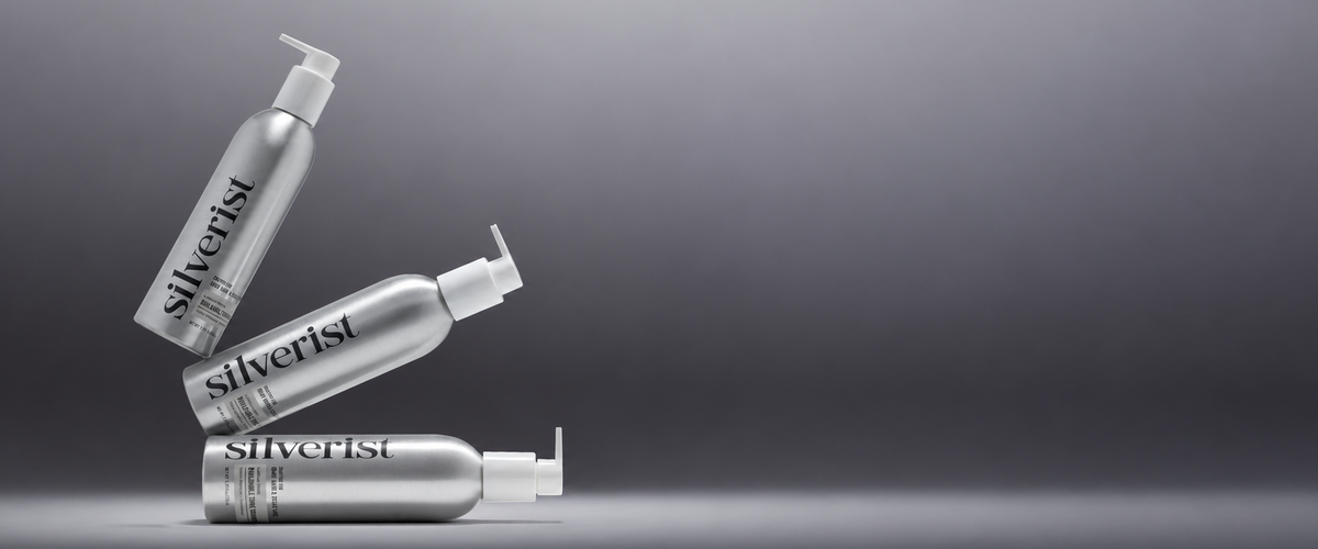 A stack of three Silverist shampoos on a grey background